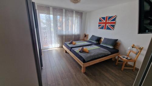 a bedroom with a bed with a flag on the wall at Ferienwohnung Wiesental 89331 Burgau, Wiesentalstrasse 1 in Burgau