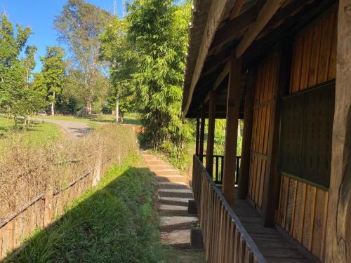 a porch of a building with a fence next to it at NernJamsai in Sop Poeng