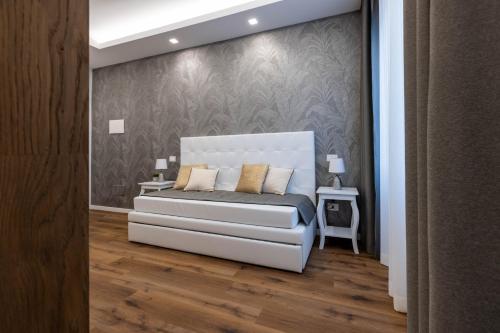 Ένα ή περισσότερα κρεβάτια σε δωμάτιο στο G MARCONI Rooms & Suites