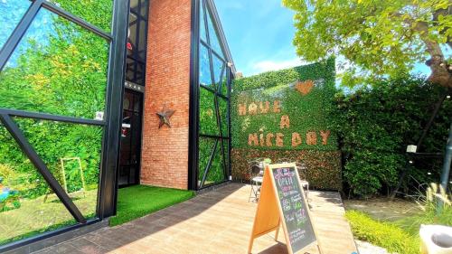 a brick building with a sign in front of it at Coco Pina in Prachuap Khiri Khan