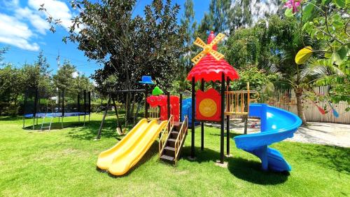 a playground with a slide and a slideintend at Coco Pina in Prachuap Khiri Khan