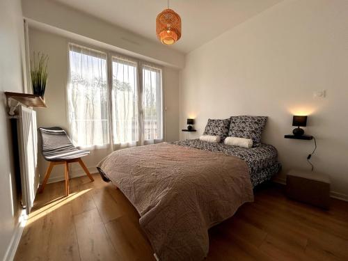 une chambre avec un lit, une chaise et une fenêtre dans l'établissement Le cocon des Maraîchers & Parking et 400 m from train station, à Avon