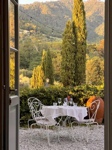 a table with wine glasses sitting on top of it at Tenuta di Tramonte Boutique Hotel in Lucca