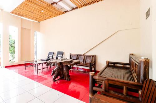 a room with a table and chairs in it at Hotel Safara Yogyakarta in Yogyakarta