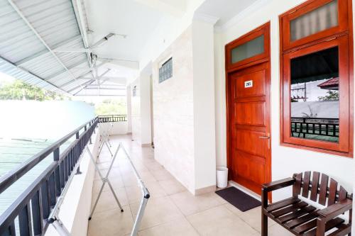 a hallway with a wooden door and a balcony at Hotel Safara Yogyakarta in Yogyakarta