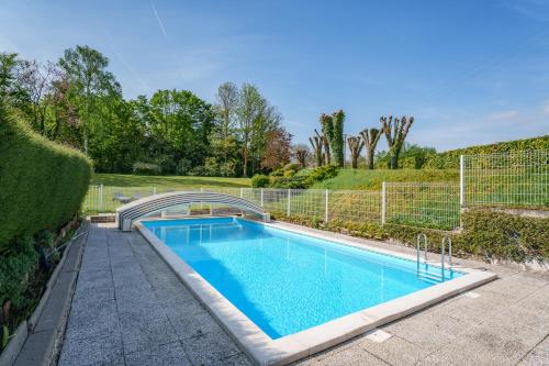 une piscine dans un jardin avec un pont dans l'établissement Maison 15 p avec piscine sud Touraine, à Brizay