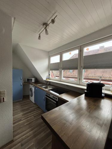 a kitchen with a table and two windows in it at See You 2 in Germersheim