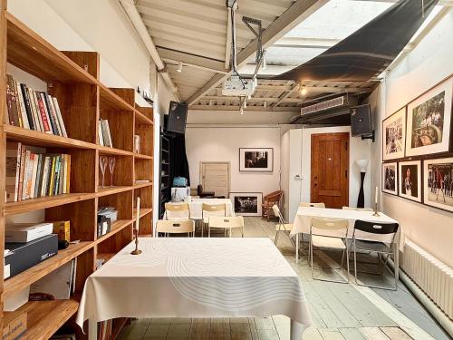 a room with tables and chairs and bookshelves at Once Linya Xiaoyuan in Chongqing