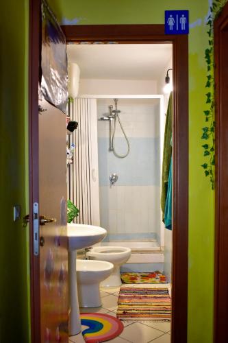 a bathroom with a toilet and a sink and a shower at Bed-Letto-Cama in Shared Room Camera Condivisa in Naples