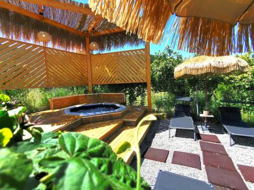 a backyard with a fire pit and an umbrella at Elite Country House in Ialyssos