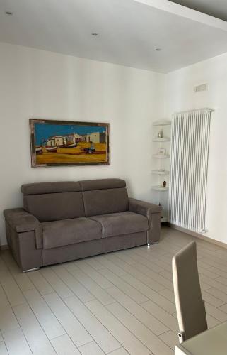 a living room with a couch and a painting on the wall at Central palace in Salerno