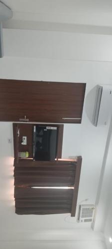 a room with a desk with a microwave on it at Buddha Dham in Mathura