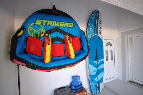 a cake on a wall next to a surfboard at Villa Redzic Residence in Brca