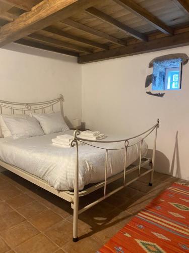 a bedroom with a bed with a metal frame at Casa da Lapa in Angra do Heroísmo