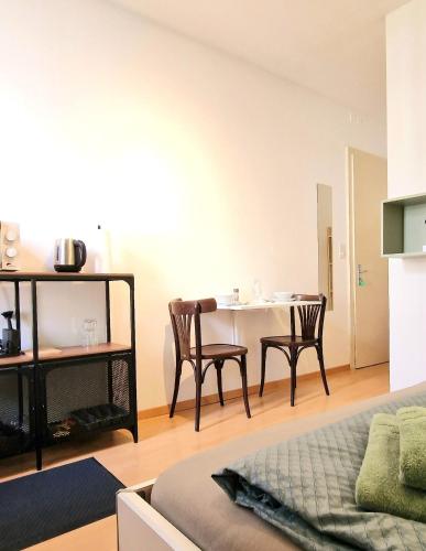 a living room with a dining room table and chairs at Casa Maria Apartments in Solothurn