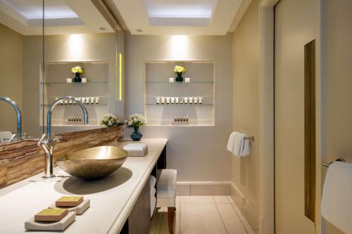 a bathroom with a large sink and a mirror at The Vista At Hilton Tel Aviv in Tel Aviv