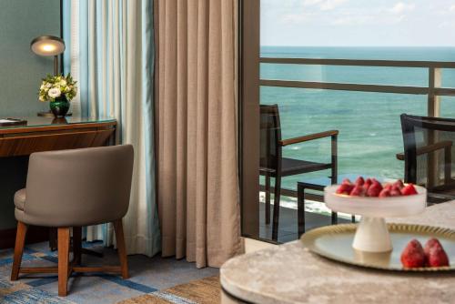 a living room with a view of the ocean at The Vista At Hilton Tel Aviv in Tel Aviv