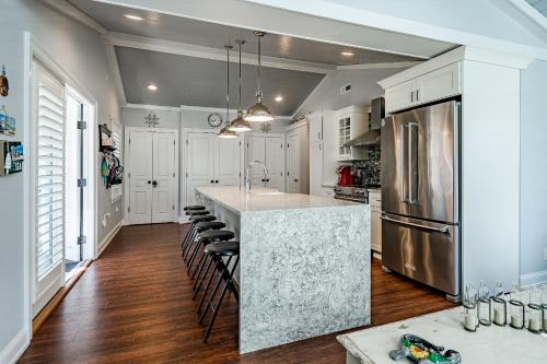 a kitchen with white cabinets and a large island with bar stools at Renovated 3-Bedroom, 2-Bath Home in Ocean Pines Peaceful Retreat Near Ocean City in Berlin