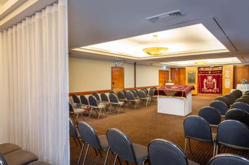 a room with rows of chairs and a podium in a room at The Vista At Hilton Tel Aviv in Tel Aviv