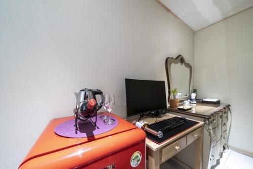 a desk with a computer on top of a red suitcase at 케일라호텔 in Uijeongbu