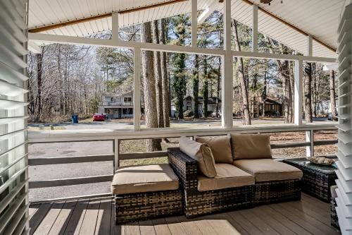 a screened porch with a couch and a large window at Renovated 3-Bedroom, 2-Bath Home in Ocean Pines Peaceful Retreat Near Ocean City in Berlin