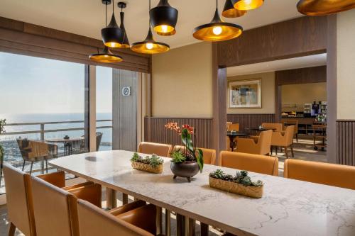 a dining room with a table and chairs at The Vista At Hilton Tel Aviv in Tel Aviv