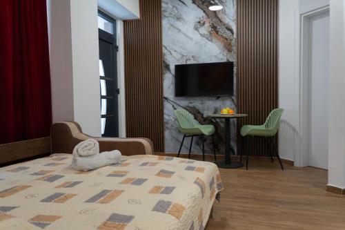 a bedroom with a bed with a stuffed animal on it at Urban Stay - Main Area Apartments in Skopje