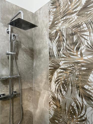 a bathroom with a shower with a mural of a plant at Rooms primo piano in Modena