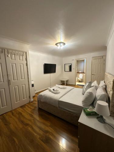 a bedroom with a large bed and a television at 3 Bedrooms Apartment with security 24 hours in London