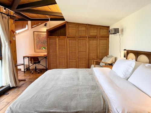 a bedroom with a large bed and a desk at Once Linya Xiaoyuan in Chongqing