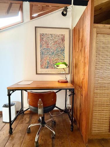 a desk with a lamp and a chair in a room at Once Linya Xiaoyuan in Chongqing