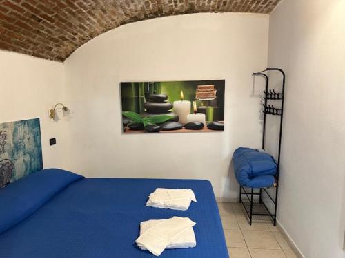 a bedroom with a blue bed and a chair at Riomaggiore Appartamenti in Riomaggiore