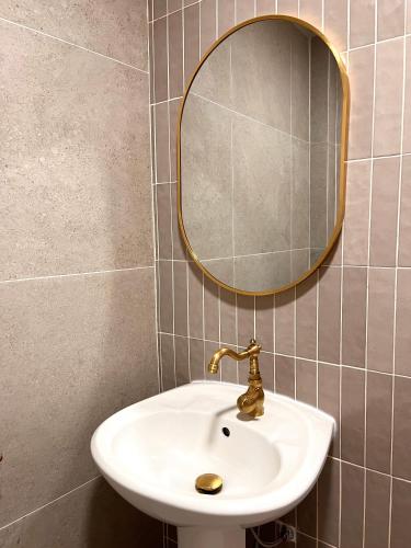 a bathroom with a sink and a mirror at IKO homes in Kota Kinabalu