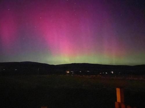 a rainbow in the night sky with the stars at Dalchalm Hideaway in Brora