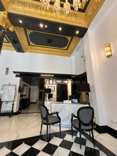 a lobby with a gold ceiling and chairs at Adriano Boutique Sevilla in Seville