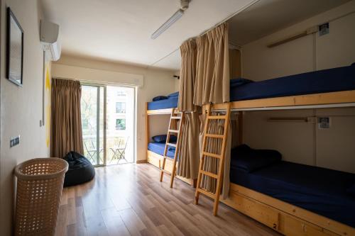 Postel nebo postele na pokoji v ubytování Battuta Hostel