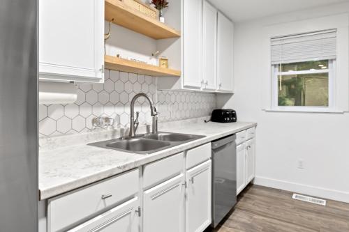 a kitchen with white cabinets and a sink at Charming Single-Family Home Between Ocean City & Assateague Island Pet-Friendly Retreat in Berlin