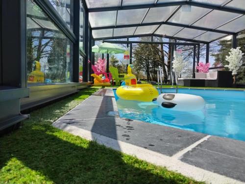 a swimming pool with an inflatable at La Roulotte du Parc in Saint-Priest-des-Champs