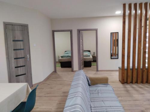 a living room with a couch and a bed at Forest Apartman in Nyíregyháza