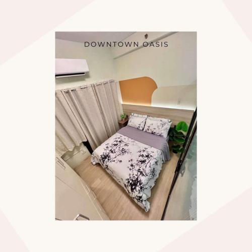 a small bedroom with a bed and a curtain at Downtown Oasis Prime Location Next to SM Ecoland in Davao City
