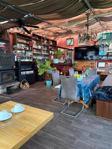 a dining room with a table and a fireplace at Schiffspension Luise in Potsdam