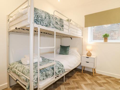 a bedroom with two bunk beds in a room at The Old Parlour in Alton