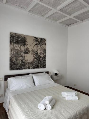 a bedroom with a bed with two towels on it at Edward House in La Spezia