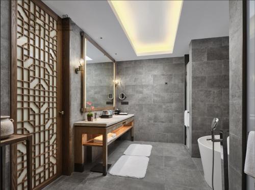 a bathroom with a sink and a mirror at Wanda Realm Yan'an in Yan'an