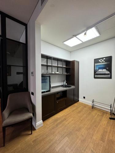 an office with a desk and a chair in a room at Esentai City Comfort in Almaty