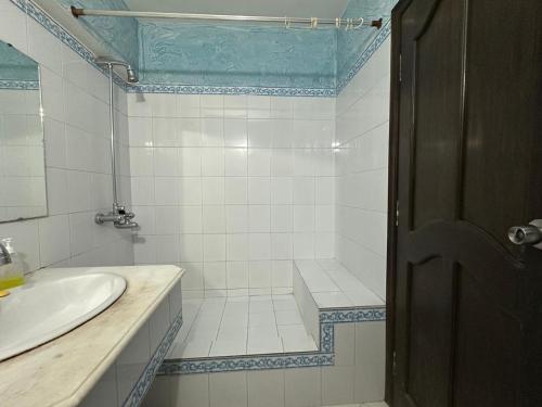 a bathroom with a tub and a sink and a shower at Best Holiday Apartment in Bhurban