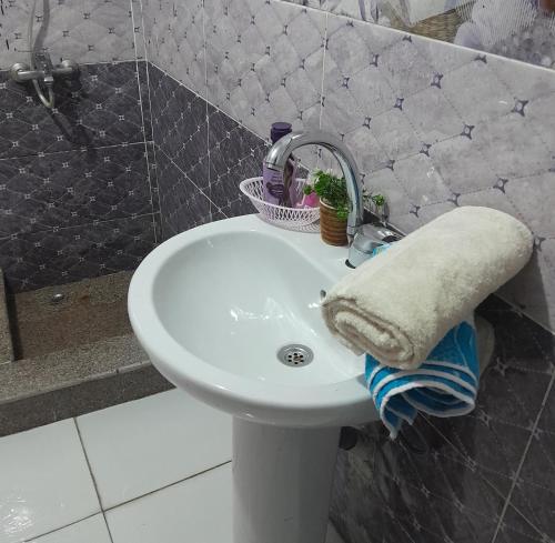 a white bathroom sink with a towel on it at yaso apartment in Cairo