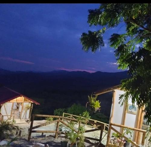 a view from the mountain top at night at El Eden Glamping cabañas Girardot in Girardot