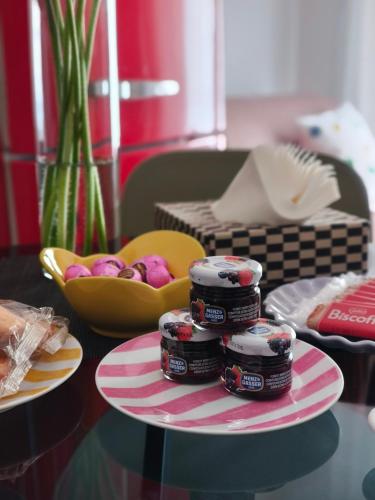 a table with a plate of jam and a bowl of fruit at Fluère - Via Riva Reno in Bologna