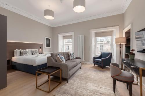 a hotel room with a bed and a couch at Destiny Scotland George IV Apartments in Edinburgh